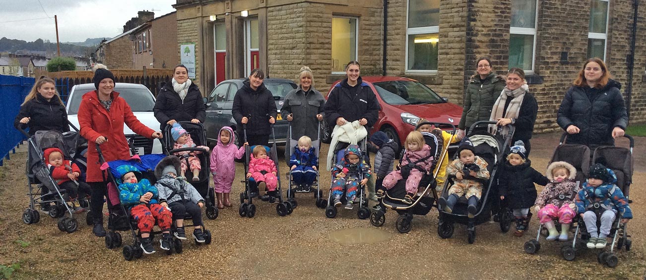 The wonderful team of adults and children who took part in the sponsored walk, outside our Padiham nursery.