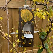 Recycled milk carton bird feeder. Recycled milk carton bird feeder.